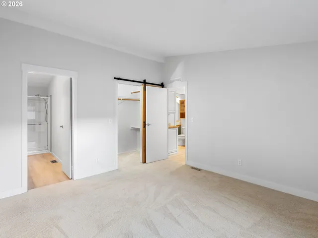 a view of hallway with bathroom