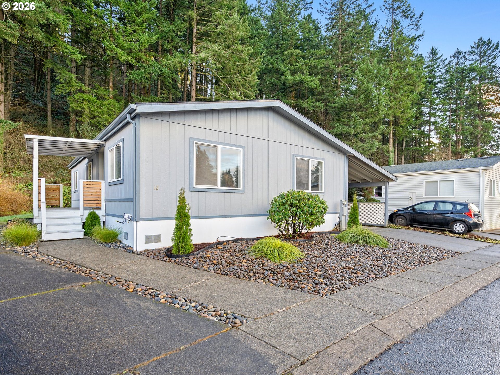 15768 Southeast Powell Boulevard, Unit 12 Portland, OR 97236 - Photo 3 of 31 a front view of a house with garden