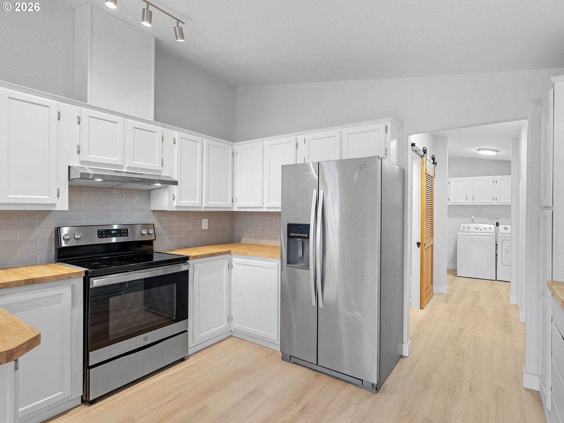 15768 Southeast Powell Boulevard, Unit 12 Portland, OR 97236 - Photo 9 of 31 a kitchen with stainless steel appliances a stove a refrigerator and a sink