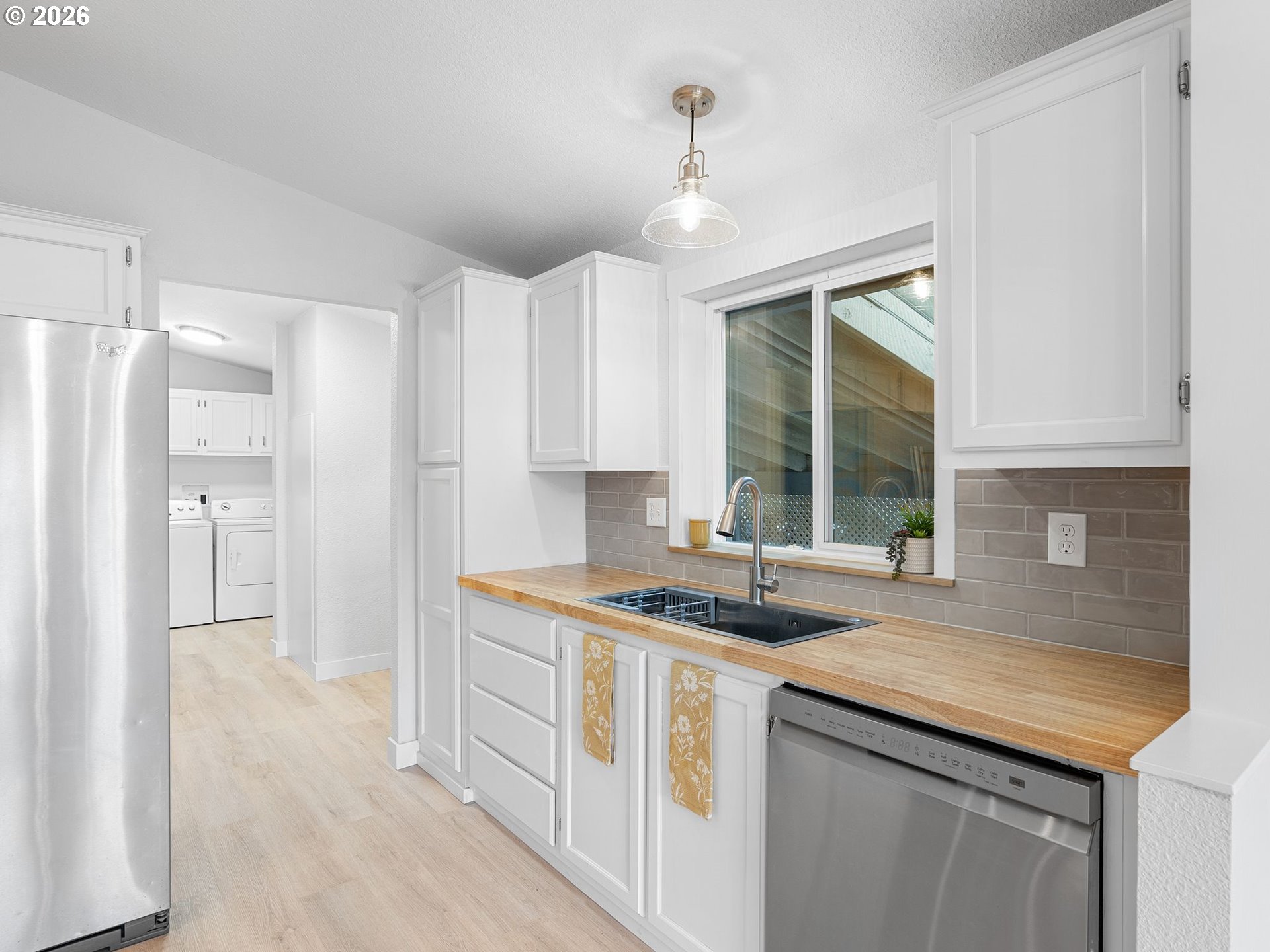 15768 Southeast Powell Boulevard, Unit 12 Portland, OR 97236 - Photo 10 of 31 a kitchen with stainless steel appliances granite countertop a sink and a refrigerator