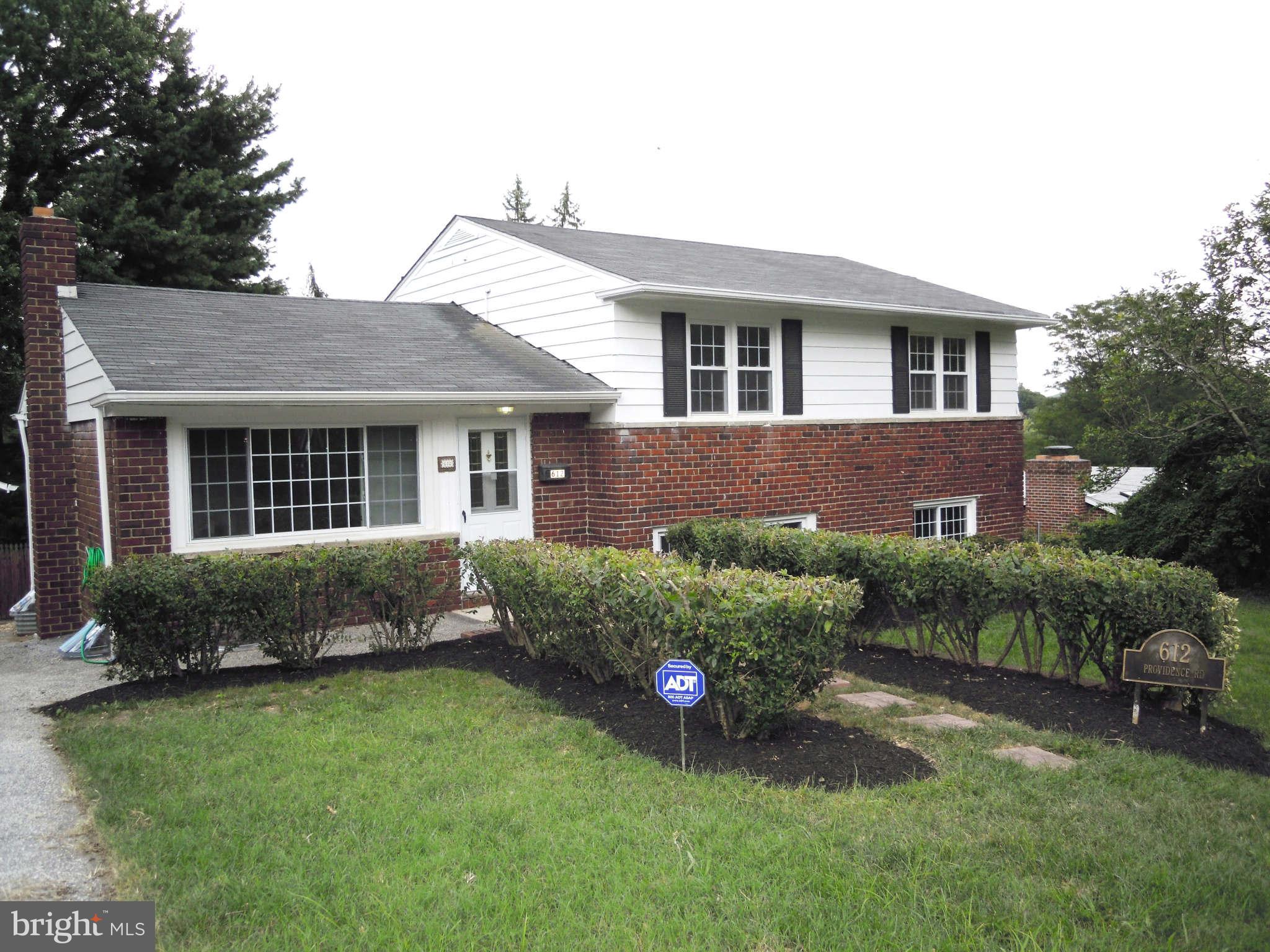 612 Providence Road Baltimore, MD 21286 - Photo 1 of 24 a front view of a house with a garden