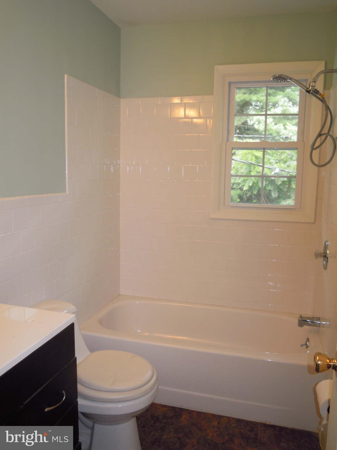 612 Providence Road Baltimore, MD 21286 - Photo 13 of 24 a bathroom with a sink a toilet and a bathtub