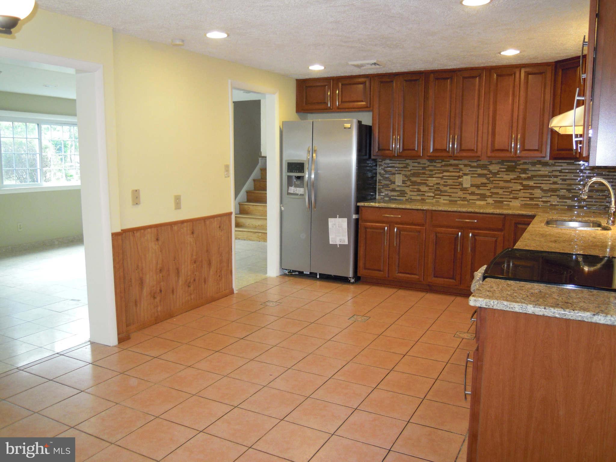 612 Providence Road Baltimore, MD 21286 - Photo 4 of 24 a kitchen with stainless steel appliances granite countertop a refrigerator a stove and a sink