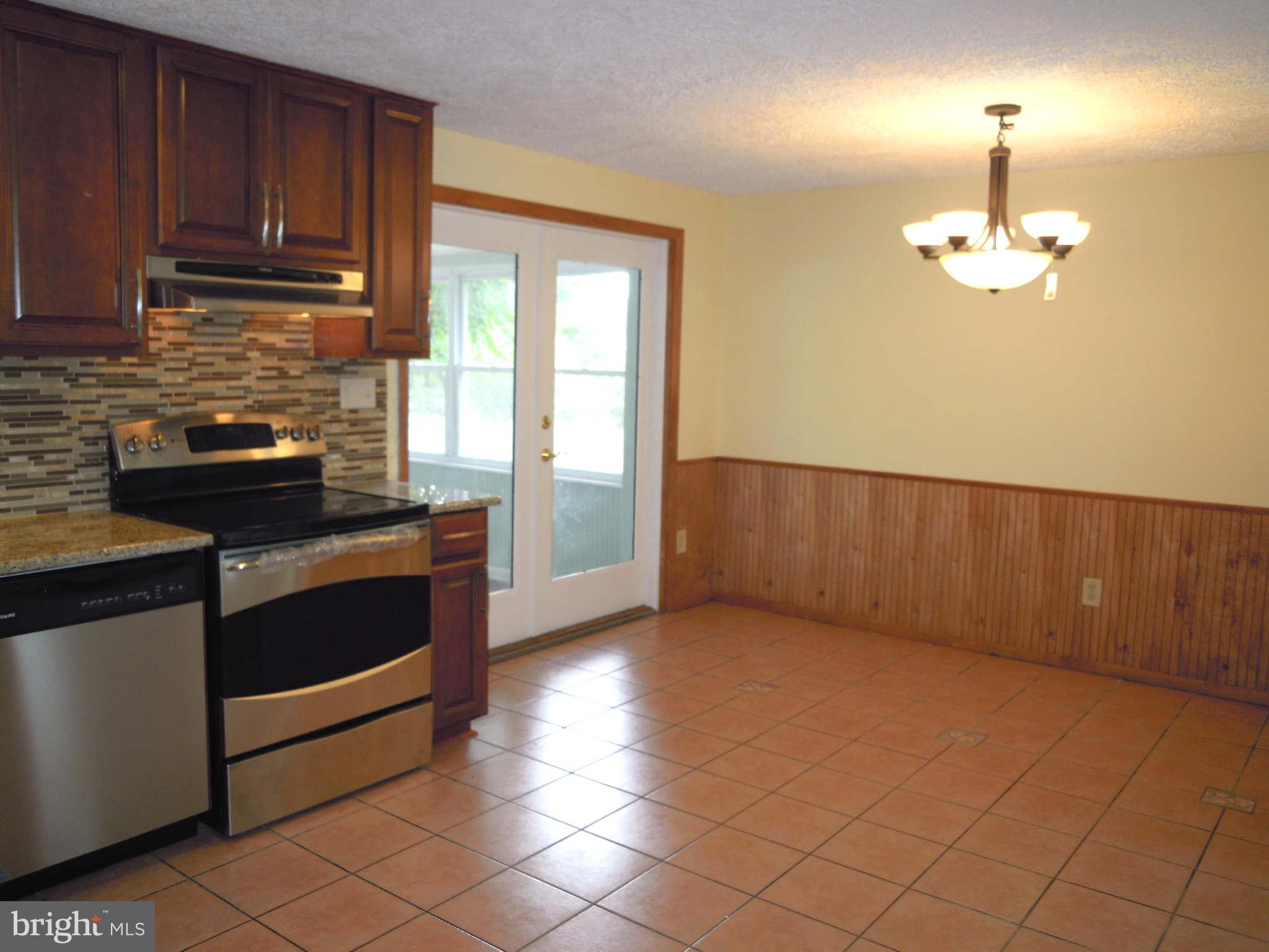 612 Providence Road Baltimore, MD 21286 - Photo 5 of 24 a kitchen with granite countertop a stove cabinets and a counter top space