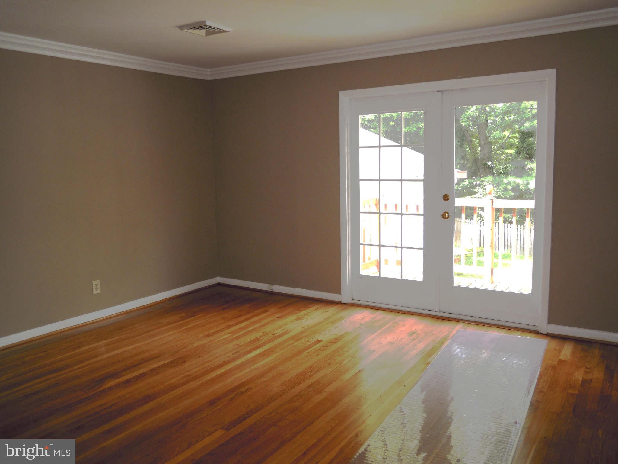 612 Providence Road Baltimore, MD 21286 - Photo 8 of 24 a view of an empty room with wooden floor and a window