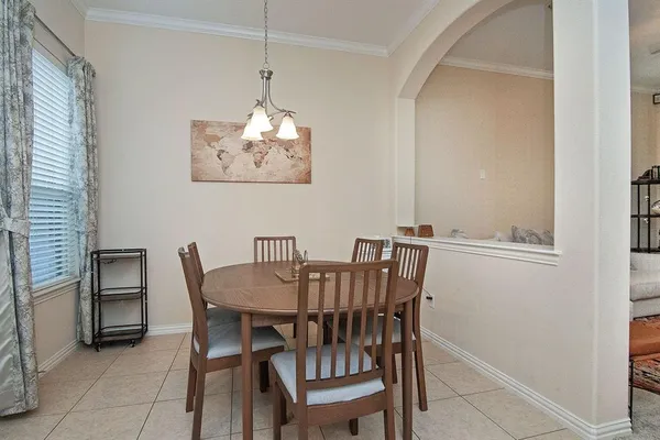 a view of a dining room with furniture and chandelier