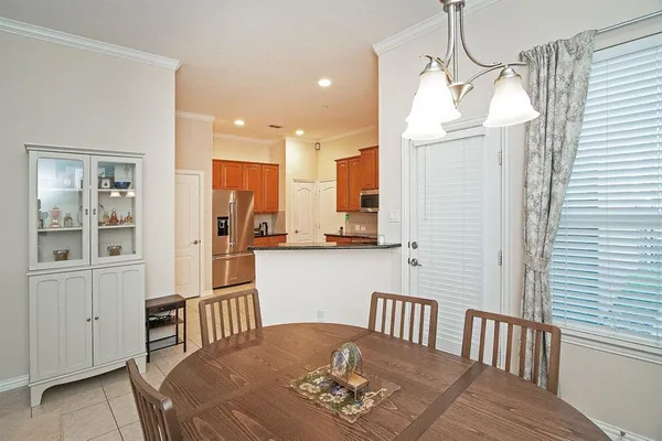 a view of a hallway with dining area chandelier