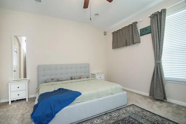 a bedroom with a bed and a window