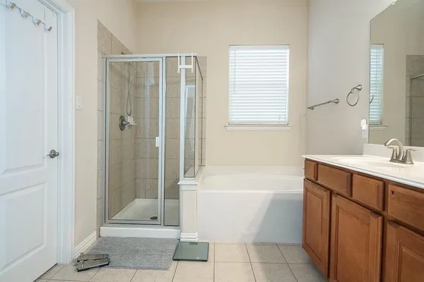 a bathroom with a bathtub a sink and a shower