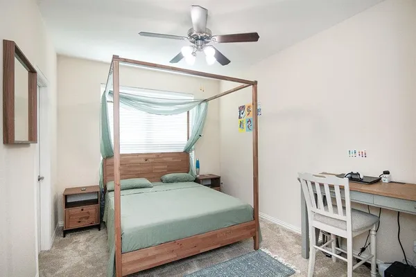a bedroom with a bed and a table in it