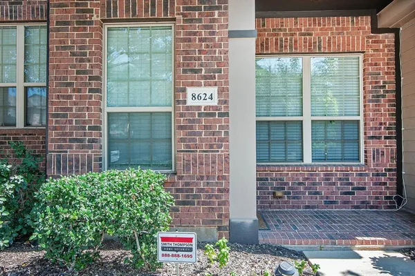 a view of a brick house with a potted plant and a potted plant