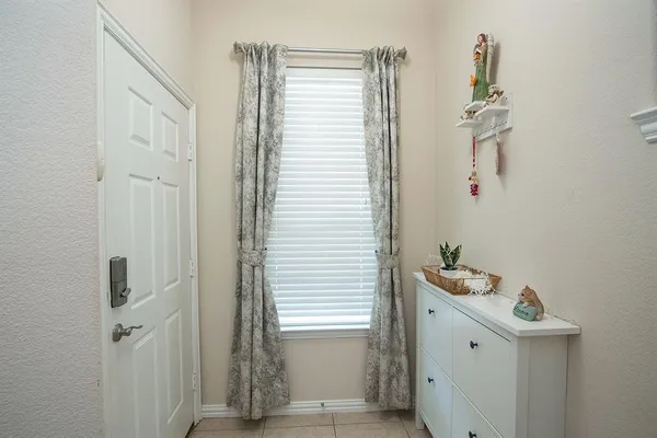 a bathroom with a window and a shower