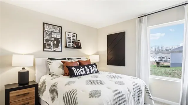 a bedroom with a large bed and a window