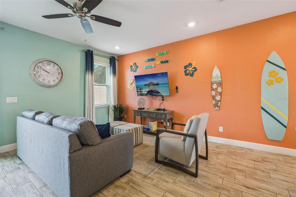 2949 Caribbean Soul Drive Kissimmee, FL 34747 - Photo 15 of 88 a living room with furniture and a large window