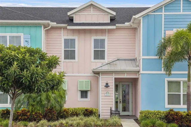 a front view of a house with plants
