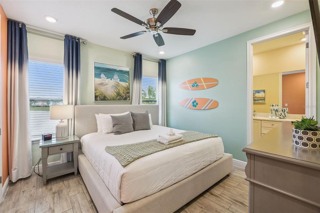 2949 Caribbean Soul Drive Kissimmee, FL 34747 - Photo 22 of 88 a bedroom with a large bed and a chandelier