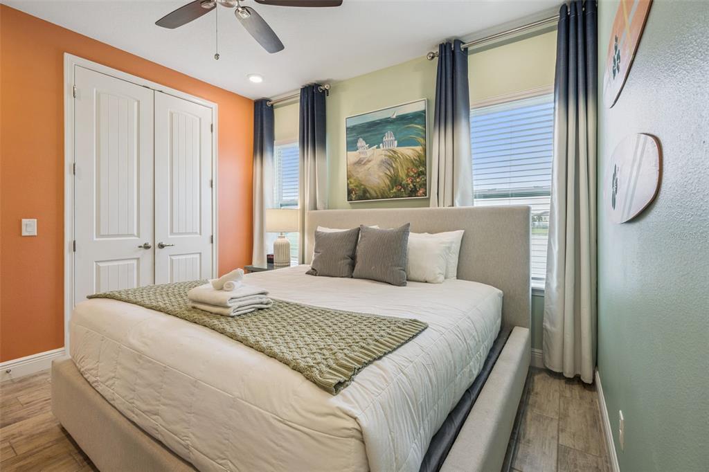 2949 Caribbean Soul Drive Kissimmee, FL 34747 - Photo 24 of 88 a bedroom with a large bed and a chandelier