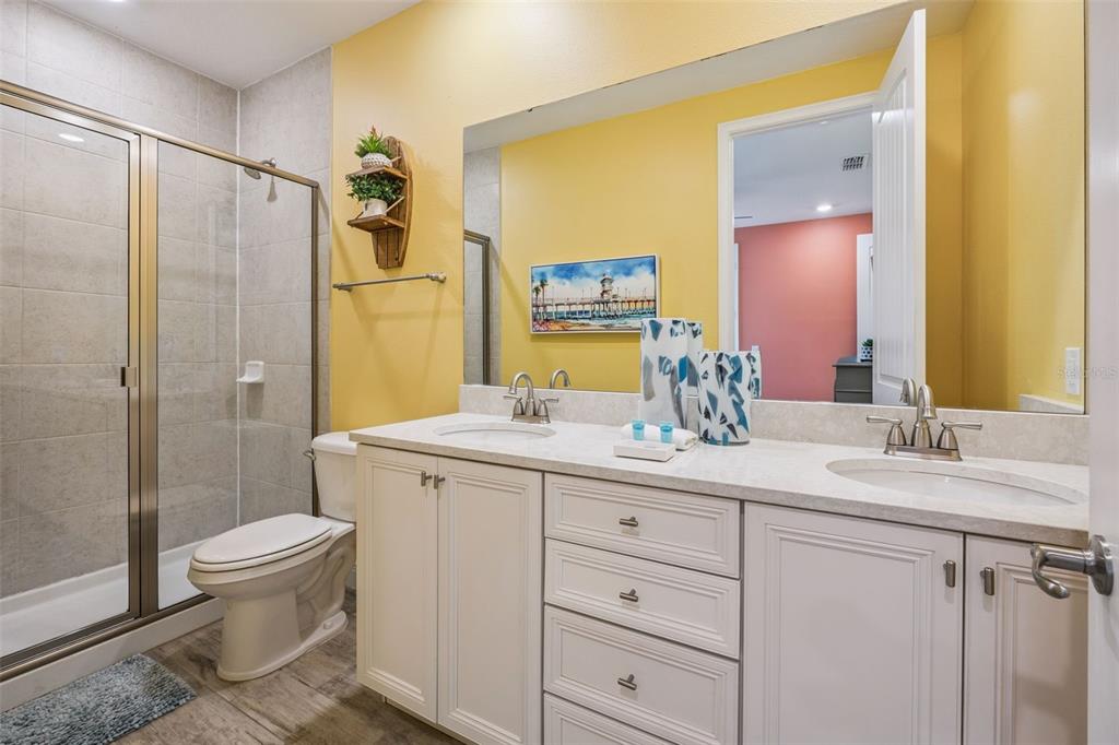 2949 Caribbean Soul Drive Kissimmee, FL 34747 - Photo 25 of 88 a bathroom with a double vanity sink toilet and shower