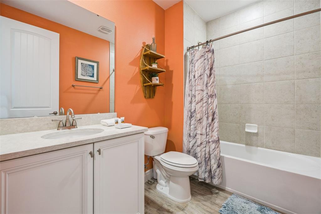 2949 Caribbean Soul Drive Kissimmee, FL 34747 - Photo 28 of 88 a bathroom with a sink a toilet and a bathtub