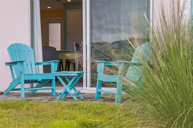 an aerial view of residential houses with outdoor space and trees