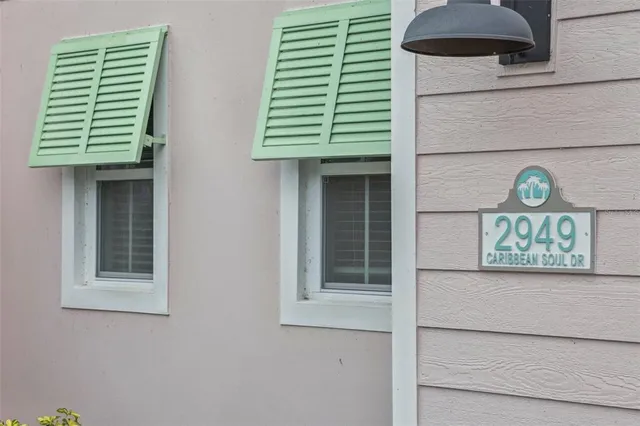 a kitchen with stainless steel appliances a sink a stove a microwave a center island and cabinets