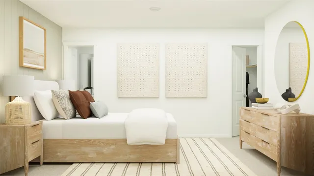 a bedroom with a bed a mirror and lamp