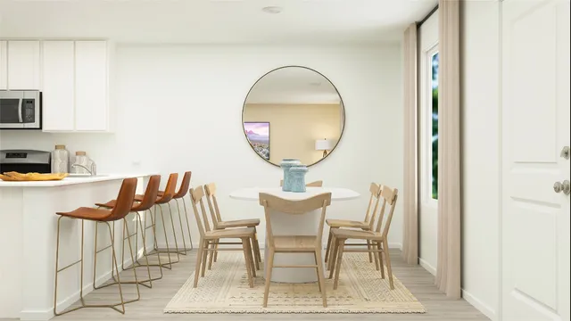 a view of a dining room with furniture and a mirror