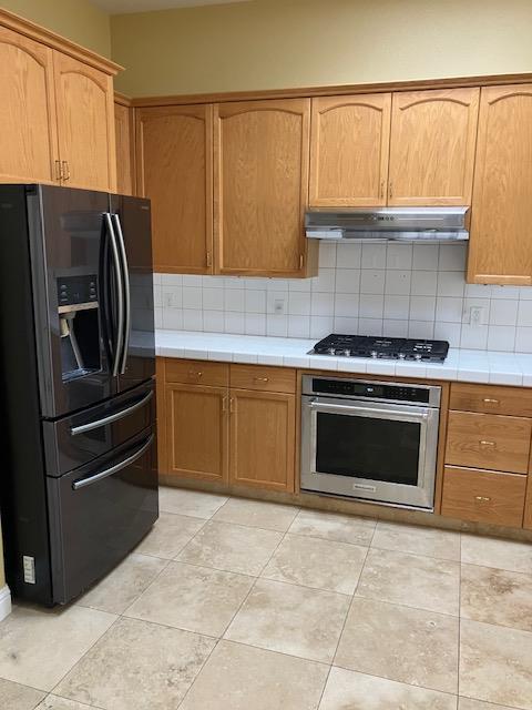 2157 West Rue St Michel Fresno, CA 93711 - Photo 7 of 22 a kitchen with granite countertop a stove top oven cabinets and stainless steel appliances