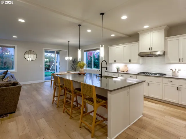 a kitchen with stainless steel appliances kitchen island granite countertop a sink and cabinets