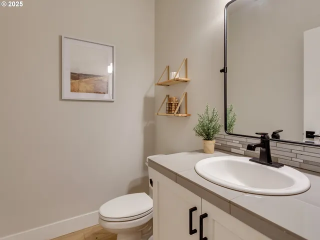 a bathroom with a toilet a sink and mirror