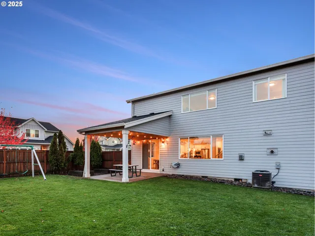 a view of a backyard with table and chairs and potted plants