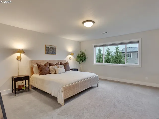 a bedroom with a large bed and a window