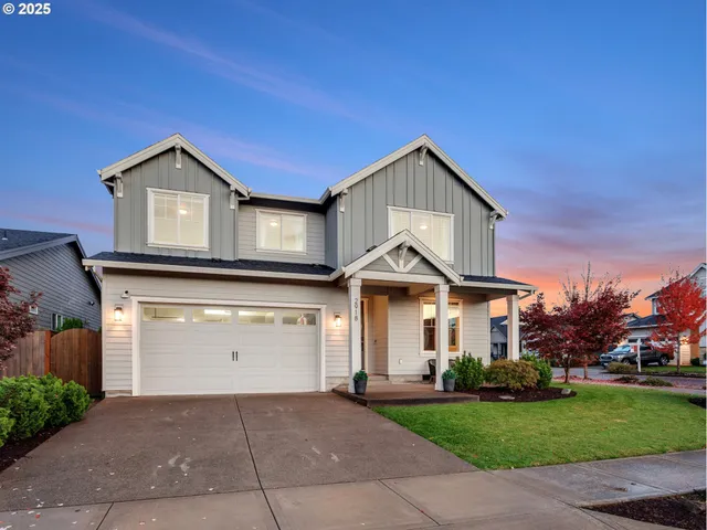 a front view of a house with a yard and garage