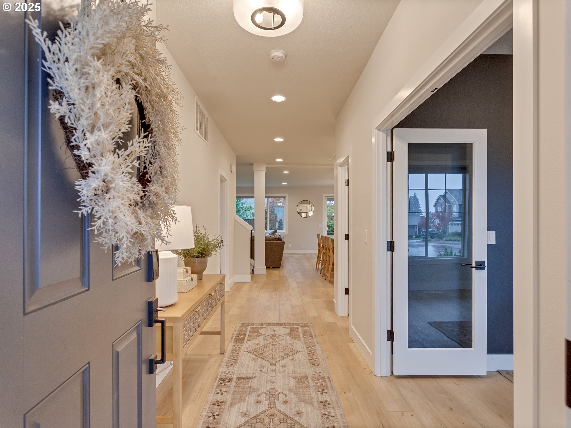 2918 Juniper Drive Newberg, OR 97132 - Photo 10 of 42 a view of a hallway with wooden floor and living room