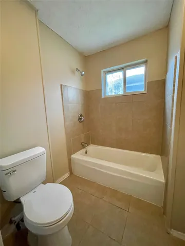 a bathroom with a toilet and a bathtub