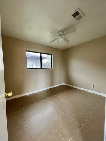 an empty room with a empty space and windows