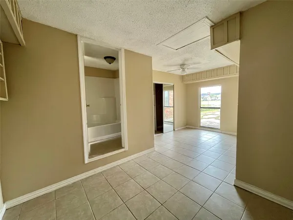 a view of a hallway with wooden shelves
