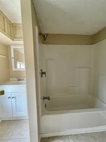 a bathroom with a shower and a sink