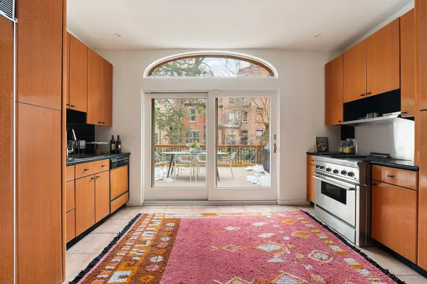 a dining room with furniture a fireplace and wooden floor