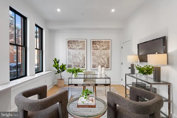 a living room with furniture and a potted plant