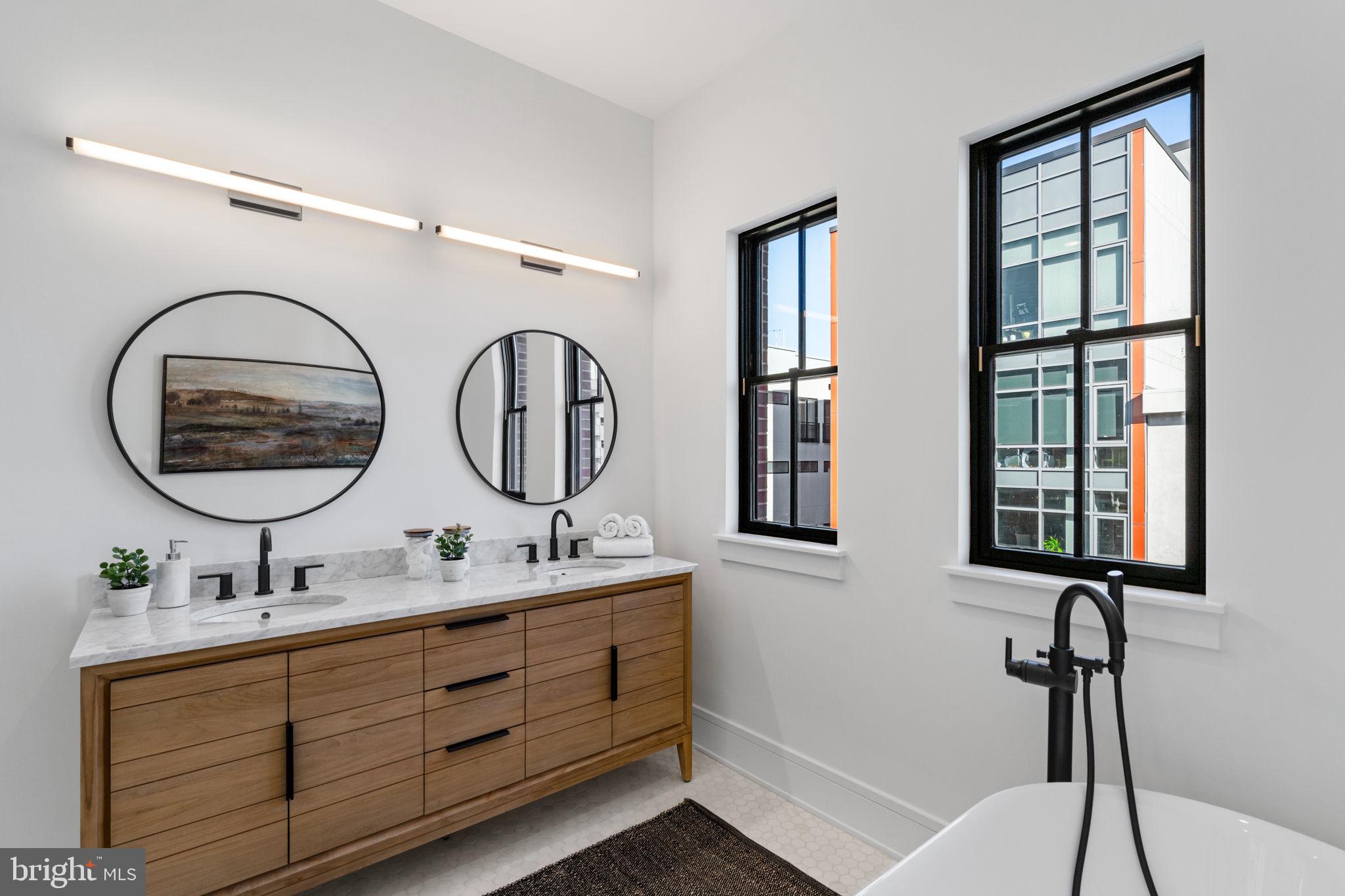 249 Philip Way Philadelphia, PA 19106 - Photo 42 of 61 a bathroom with a double vanity sink and a mirror