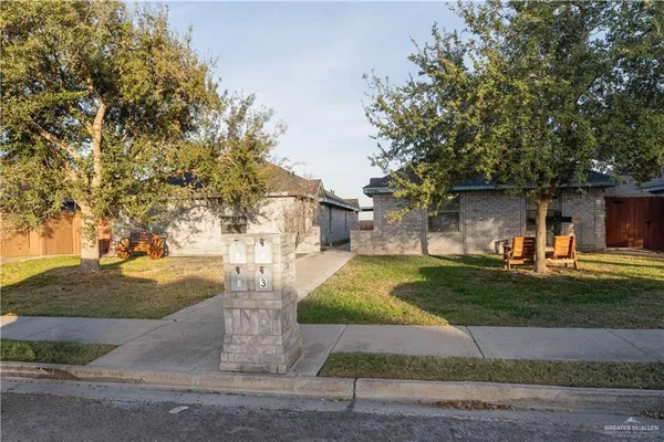 a front view of a house with a yard garage and outdoor seating