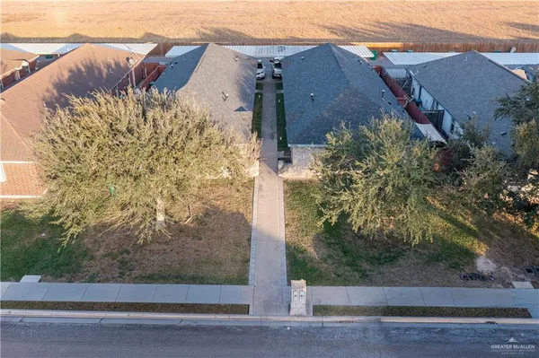 front view of a brick house with a yard