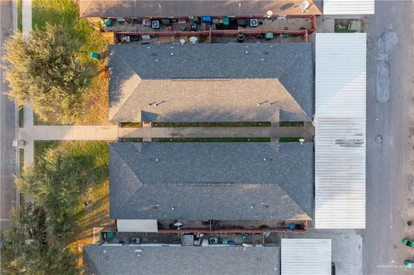 an aerial view of a house with a yard