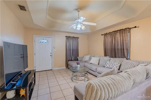 a living room with furniture and a chandelier
