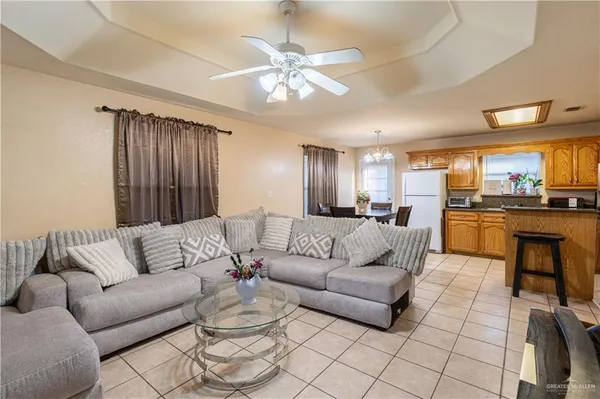 a living room with furniture and kitchen view