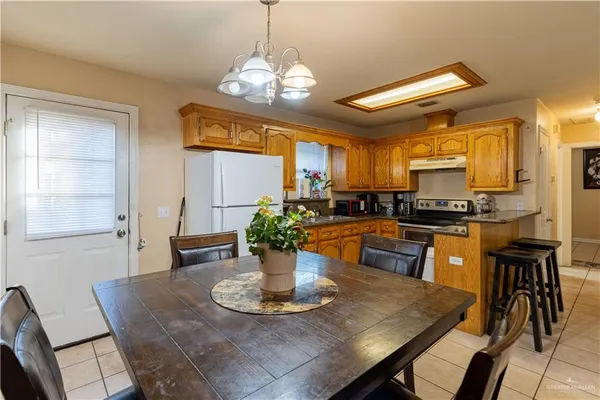 a kitchen with a table and chairs