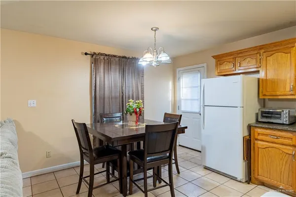 a view of a dining room with furniture and a chandelier