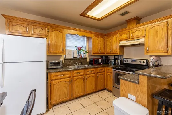 a kitchen with a sink appliances and cabinets
