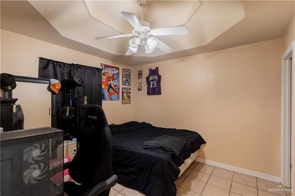 a bedroom with a bed and a ceiling fan